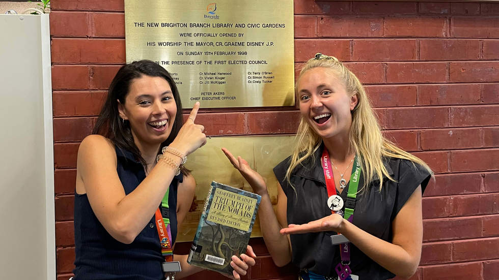 Two librarians with the new Brighton Library plaque marking 25 years