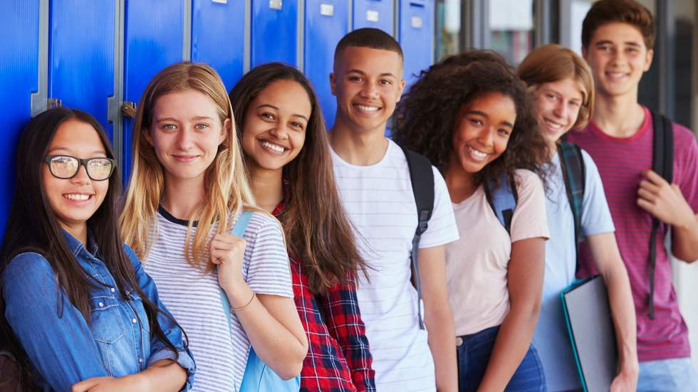 group of teenagers at school beside lockers