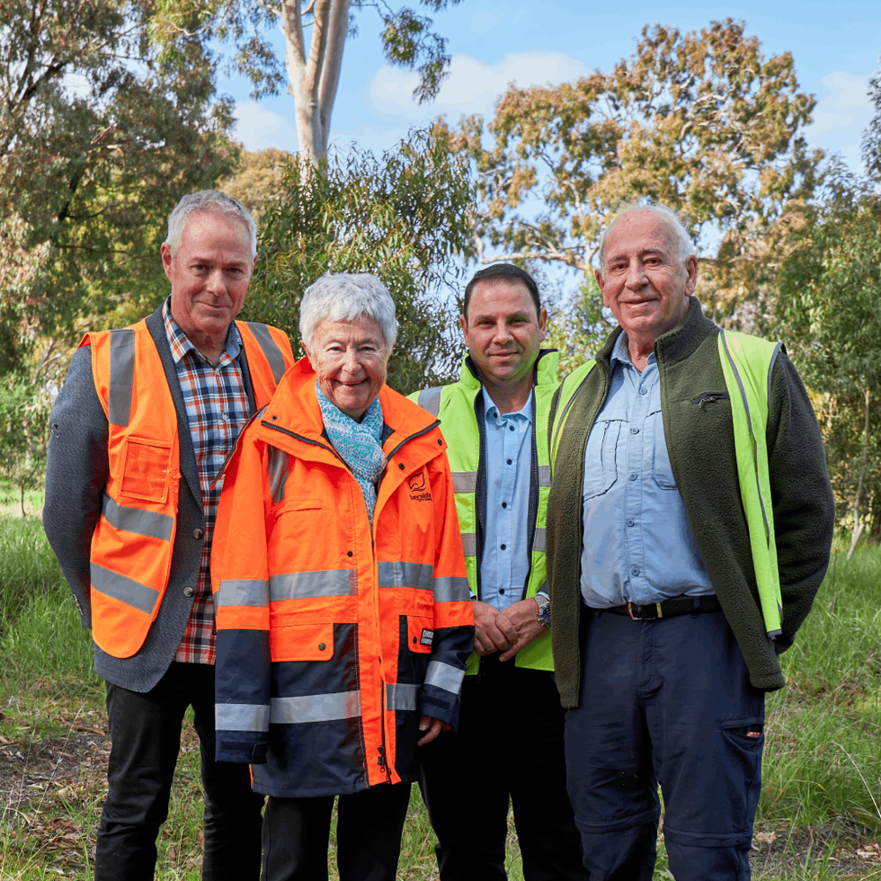Mick Cummins, Pauline Reynolds, Hanna El Mouallem and Michael Norris smiling with green trees in the background