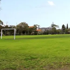 Sillitoe Reserve green grass soccer pitch on a mostly fine day with goal in the left foreground 