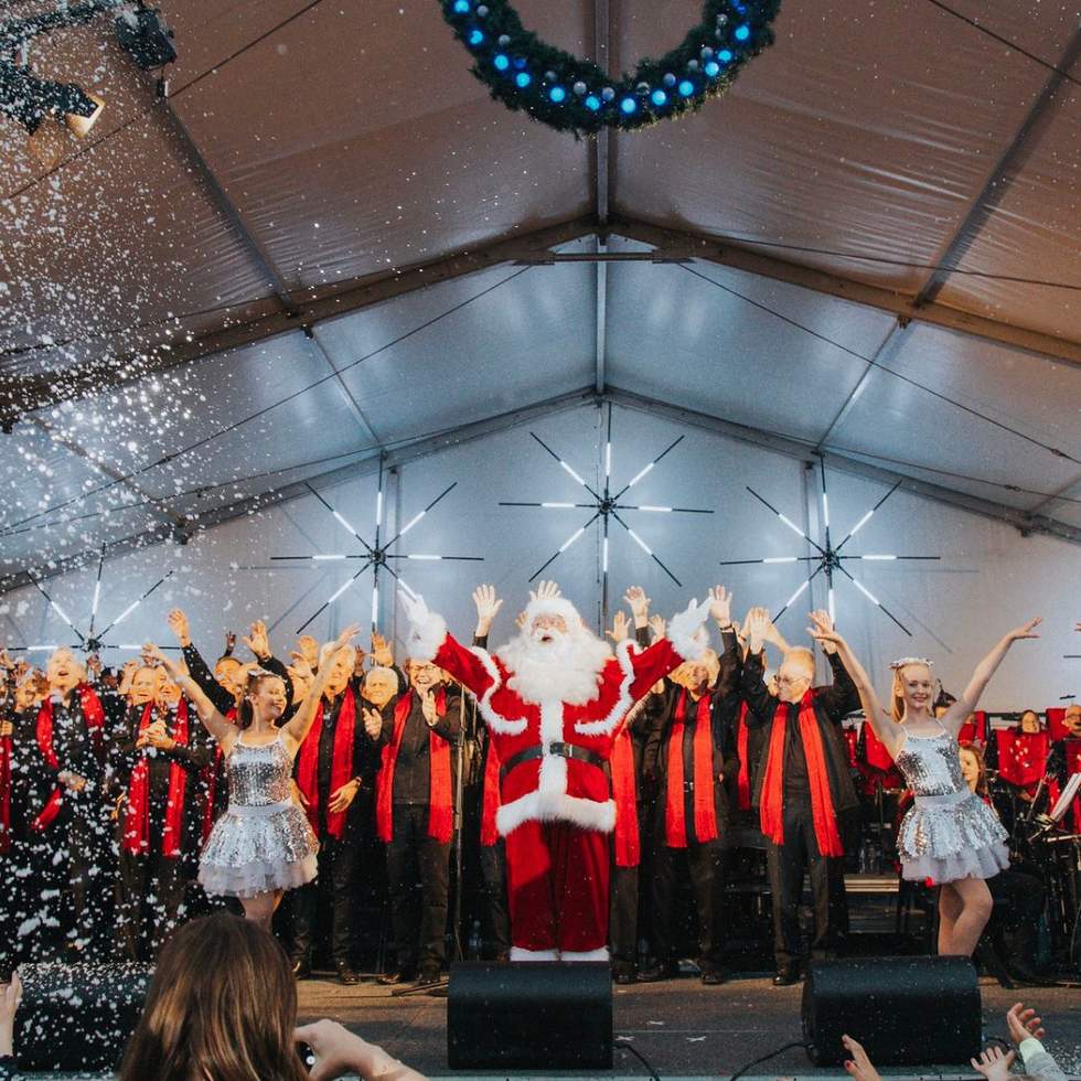 Santa on stage at with dancers and singers