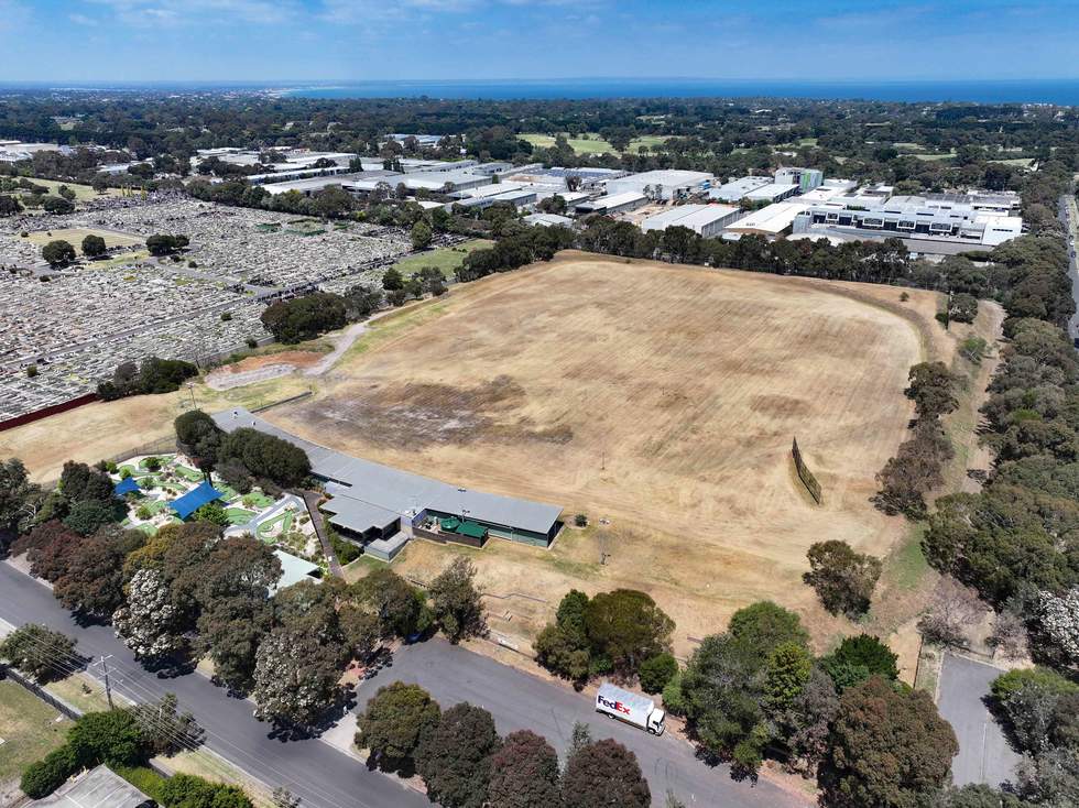 Aerial photo of the former Sandringham golf driving range and mini golf at 20 Wangara Road in the foreground, with commercial and residential buildings and the bay in the background.