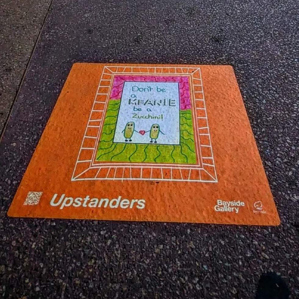 Sticker on the pavement with kids drawing of an anti bullying message