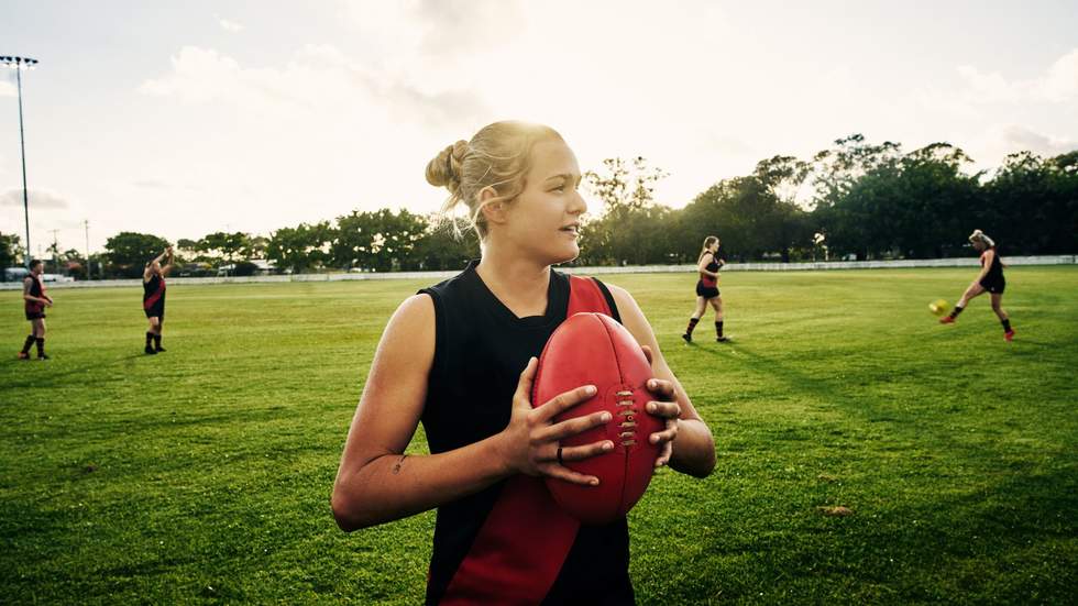 Young girls playing Aussie Rules.